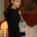 Sunday’s Best pearl and crystal bag worn with a black jacket and jeans