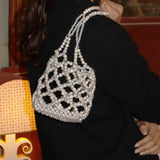 Close-up editorial of Sunday’s Best pearl and crystal shoulder bag